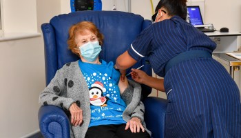 Margaret Keenan, 90, is the first patient in the United Kingdom to receive the Pfizer/BioNtech COVID-19 vaccine at the start of the largest ever immunization program in history on December 8, 2020 in the U.K.