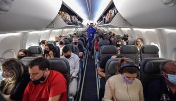 Passengers take their seats before take off in a Boeing 737 Max aircraft operated by low-cost airline Gol at Guarulhos International Airport, near Sao Paulo, Brazil, on December 9, 2020.