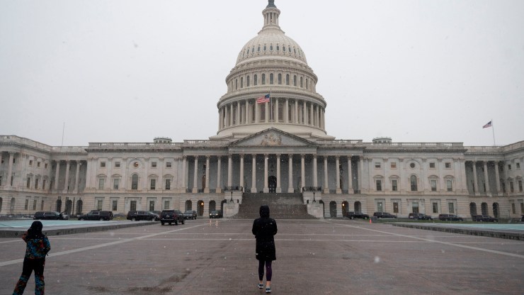 People walk past the U.S. Capitol in Washington, D.C., on December 16, 2020.