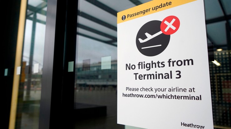 A sign alerts travels to the closure of Terminal 3 at Heathrow Airport in west London on Dec. 21, 2020, as a string of countries around the world banned travelers arriving from the U.K., due to the rapid spread of a new, more-infectious coronavirus strain.