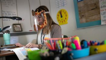 A second grade teacher wears a decorative face shield while reading to her class at an elementary school in Stamford, Connecticut, in October.
