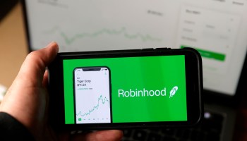 In this photo illustration, the Robinhood logo is displayed on an iPhone.