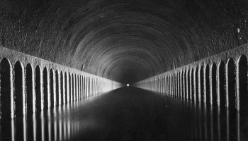 circa 1930: Light shines on the canal at the end of the Tunnel de Roue, near Marseilles. (Photo by Henry Guttmann Collection/Hulton Archive/Getty Images)