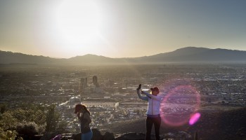A woman takes a selfie with a smart phone from atop Tumamoc Hill during sunrise May 13, 2015 in Tucson, Arizona.
