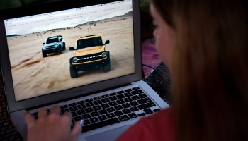 A person watching the 2021 Ford Bronco family world premiere on a computer in Arlington, Virginia, on July 13, 2020.