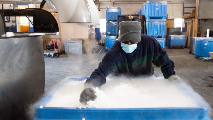An employee makes dry ice pellets at Capitol Carbonic, a dry ice factory, in Baltimore, Maryland, Nov. 20, 2020.