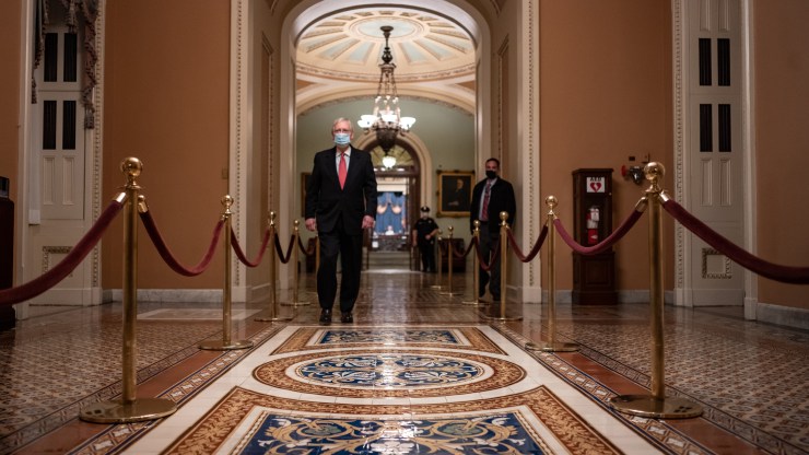 Senate Majority Leader Mitch McConnell walks to his office after leaving the Senate Floor at the U.S. Capitol on Dec. 21, 2020, in Washington, D.C.