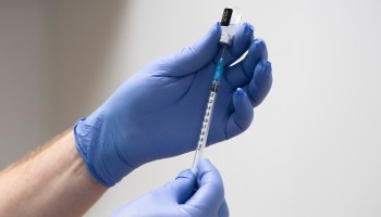 A COVID-19 vaccine is prepared at Cardiff and Vale Therapy Centre on Dec. 8 in Cardiff, Wales.