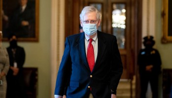 Senate Majority Leader Mitch McConnell wears a protective mask while arriving to the U.S. Capitol on Dec. 11, 2020, in Washington, D.C.