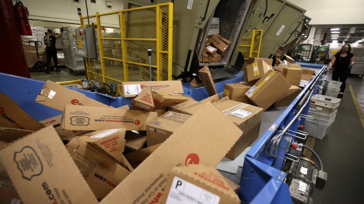 Packages are processed at a U.S. Postal Service distribution center in Oakland, California.