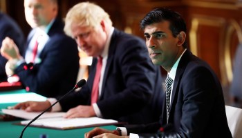 Chancellor of the Exchequer Rishi Sunak sits beside Prime Minister Boris Johnson during a meeting in July. Sunak supported reducing the U.K.'s foreign aid budget by the equivalent of $600 billion.