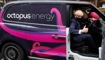 Prime Minister Boris Johnson poses in an electric taxi. His government has accelerated its plan to move the country to electric transportation.
