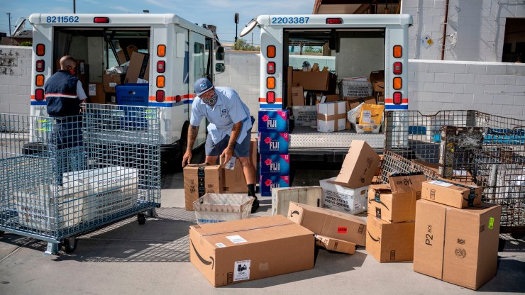 Mail carriers load up their trucks at a USPS distribution center in El Paso, Texas, earlier this year.