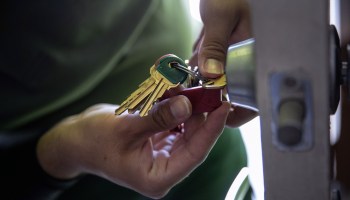 An apartment maintenance man changes the lock of an apartment after constables posted an eviction order on October 7, 2020 in Phoenix, Arizona.
