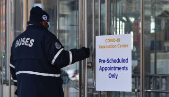 A Metropolitan Transportation Authority employee enters a COVID-19 vaccination center.