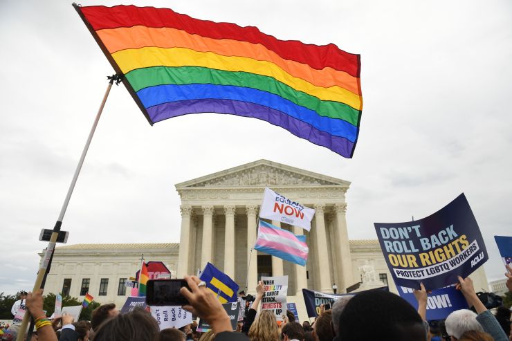 LGBTQ rights supporters rally outside the Supreme Court in Washington, D.C., Oct. 8, 2019, as the court holds oral arguments in three cases dealing with workplace discrimination based on sexual orientation.