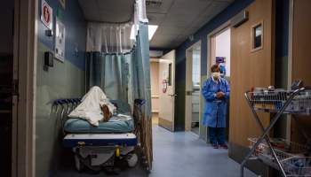 A patient rests in a corridor waiting for a room at Providence Cedars-Sinai Tarzana Medical Center in Tarzana, California on Jan. 3.