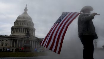Trump supporters gather at the U.S. Capitol prior to Wednesday's insurrection. “We have often lost sight of the fact that our biggest and most successful export is not capitalism, but is democracy,” said Kathleen Day, an expert on financial crises. (Photo by Olivier Douliery / AFP via Getty Images)