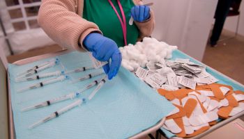 Syringes filled with a dose of the COVID-19 vaccine on a tray before being administered.
