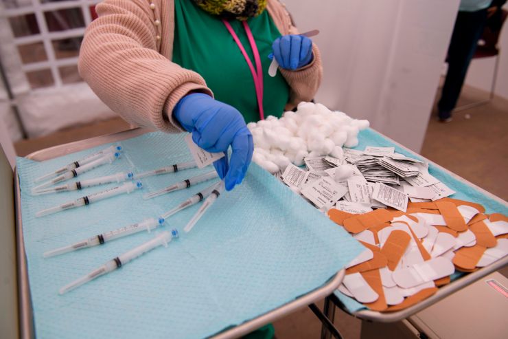 Syringes filled with a dose of the COVID-19 vaccine on a tray before being administered.