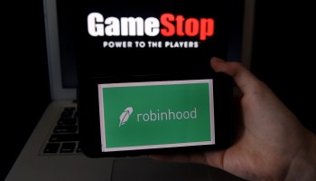 This photo illustration shows the logos of video game retail store GameStop and trading application Robinhood on a computer and on a mobile phone in Arlington, Virginia on January 28, 2021.