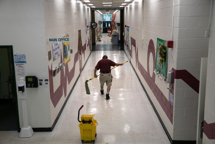 A custodian cleans ahead of the return of students for the upcoming semester at Apples Pre-K School on Aug. 26 in Stamford, Connecticut.