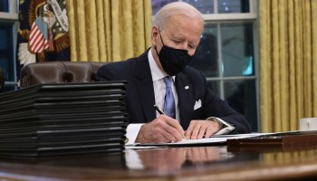 President Joe Biden prepares to sign a series of executive orders at the Resolute Desk in the Oval Office just hours after his inauguration on January 20, 2021 in Washington.