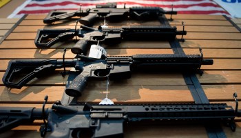 Assault rifles hang on the wall for sale at Blue Ridge Arsenal in Chantilly, Virginia, on October 6, 2017.