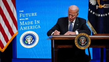 President Joe Biden signs an executive order meant to channel the government's buying power into American products.