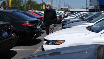 A person looks at cars at a dealership in New Jersey. Prices rose in both the new and used vehicle markets last year.