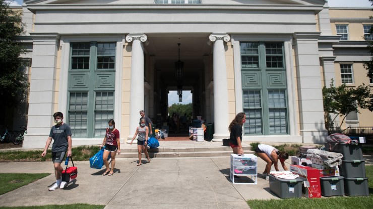 Students and their families move belongings at a campus dormitory at the University of South Carolina on Aug. 10, 2020, in Columbia, South Carolina.