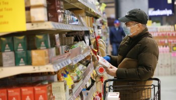A shopper grabs groceries at a supermarket in Seattle in March.