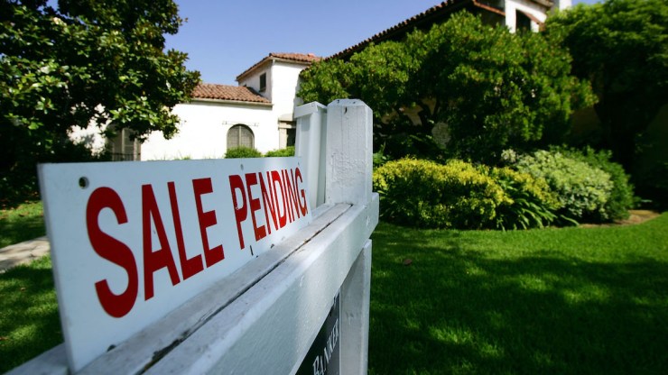 A Sale Pending sign hangs outside a house in California.