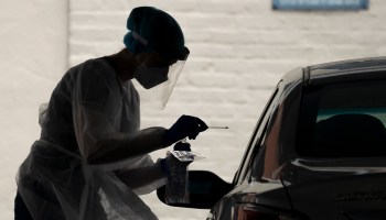 A medical professional administers a coronavirus test at a drive-thru site in Washington, D.C. last year.