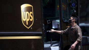 A UPS driver gets into his truck while on his delivery route on July 30, 2020 in San Francisco, California.