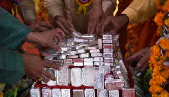 People are stacking silver bars in this photo from India on March 25, 2018.