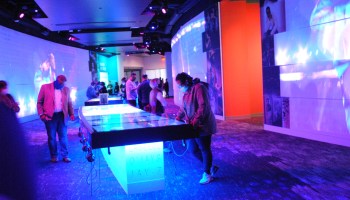 Guests enjoy interactive displays in the center of the museum, while walls feature a “takeover” performance by artist Prince.