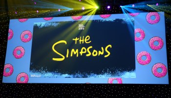 A view of the Simpsons title card projected on screen.