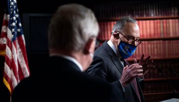 Sens. Richard Durbin, left, and Chuck Schumer discuss the COVID-19 relief bill. Tax policy changes backed by Democrats could make a big difference for low-income workers.