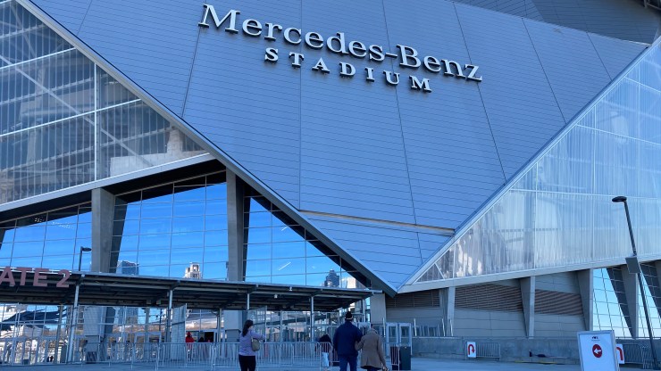 People trickle into Mercedes-Benz Stadium in Atlanta to receive COVID-19 vaccinations at the site run by the Fulton County Board of Health.