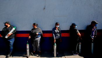 In Guadalajara, Mexico, people line up to refill oxygen tanks for relatives with COVID-19.