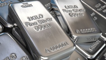 A photo illustration of silver bars stacked on top of each other.