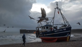 A U.K. fishing boat on the shore.