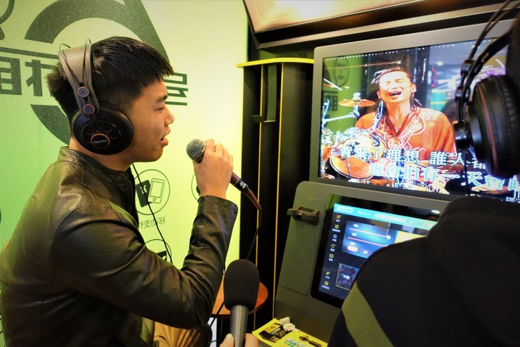 Zou Chaogang sings karaoke in Shanghai to relieve stress. Prior to the pandemic he struggled to pay rent and buy food. (Charles Zhang/Marketplace)