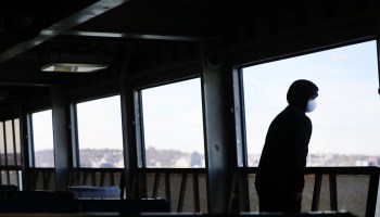 A man rides on an empty Staten Island Ferry in New York City.