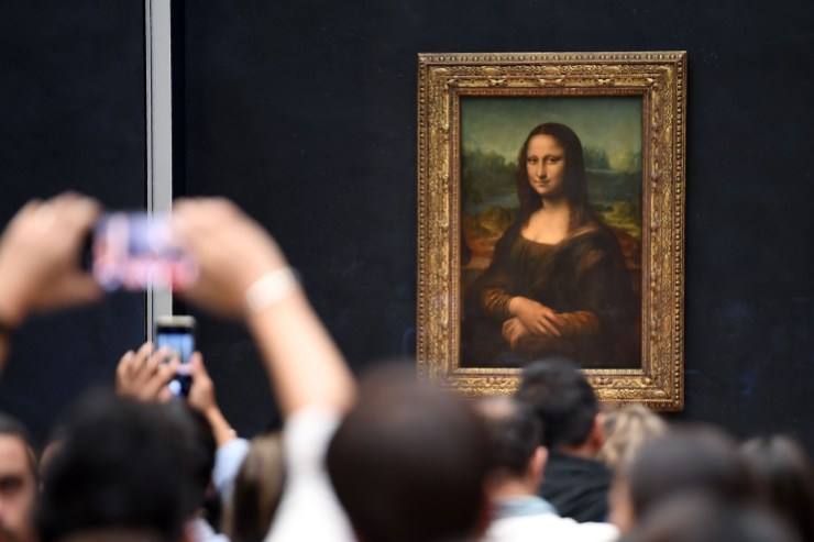 Visitors at the Louvre take pictures in front of the "Mona Lisa."
