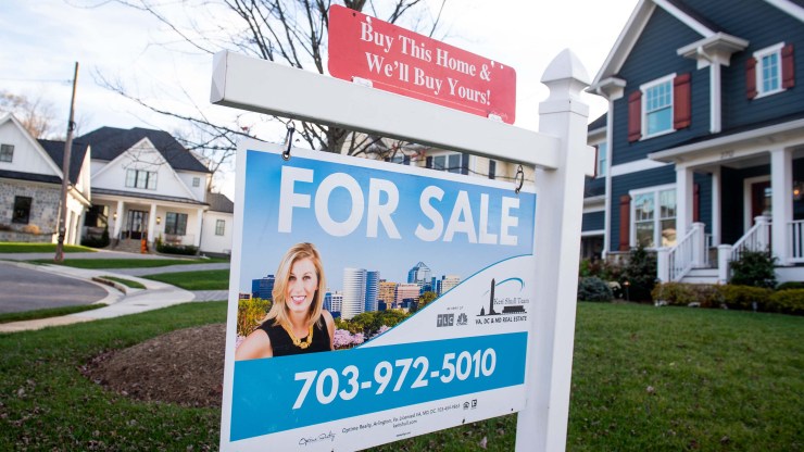 A house's "For Sale" sign is seen in front of a home in Arlington, Virginia, November 19, 2020.