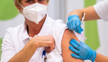 Medical personnel is given the Pfizer-BioNTech vaccine at the Favoriten Clinic in Vienna, Austria, on December 27, 2020.