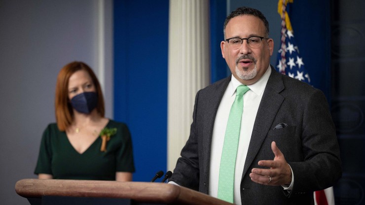Secretary of Education Miguel Cardona, right, stands next to White House Press Secretary Jen Psaki while speaking during the daily press briefing at the White House on March 17, 2021.