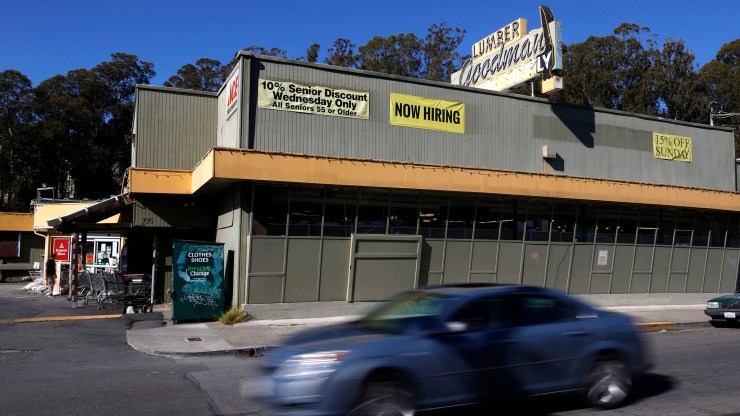 A "Now Hiring" sign is displayed on the front of Goodman Lumber on February 5, 2021 in Mill Valley, California.